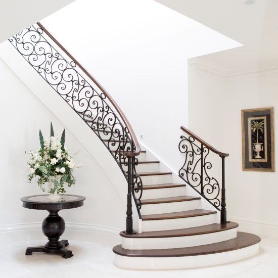 circular staircase, staircase, wrought iron staircase, wrought iron balustrade, circular balustrade, iron and timber balustrade, entry table, round entry table, floral decoration