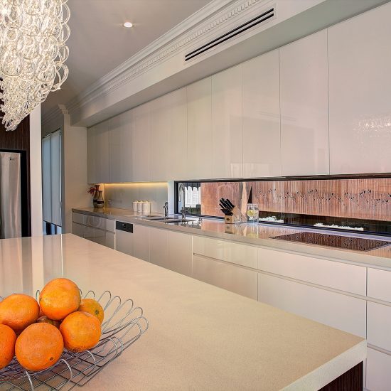 kitchen chandelier, chandelier over island, contemporary kitchen, dentil cornice, Caesarstone benchtop, woodgrain laminate