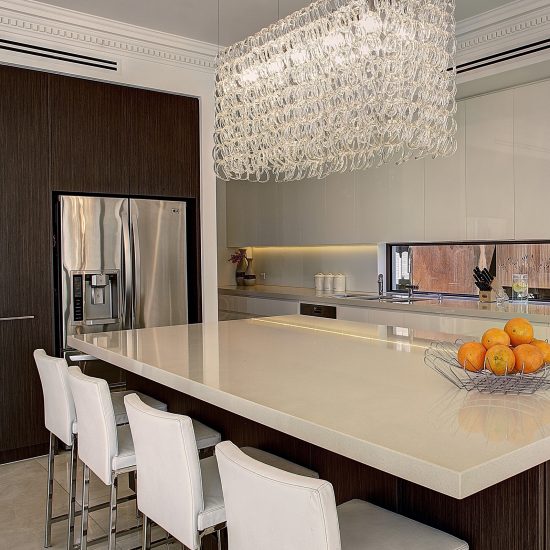 kitchen chandelier, chandelier over island, contemporary kitchen, dentil cornice, Caesarstone benchtop, woodgrain laminate