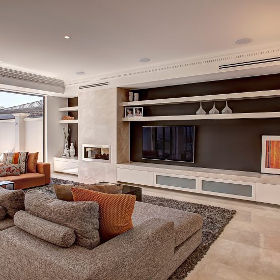 sectional sofa, custom sofa, chaise sofa, chaise, orange décor, family room, contemporary family room, grey rug, fireplace, built-in fireplace, gas fireplace, marble fireplace, entertainment unit, built-in entertainment unit, marble entertainment unit, marble tiles, marble floor tiles, wall hung TV