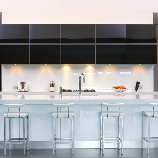 kitchen design, black cabinets, black gloss cabinets, white benchtop, stone benchtop, glass splashback. White splashback, white glass splashback