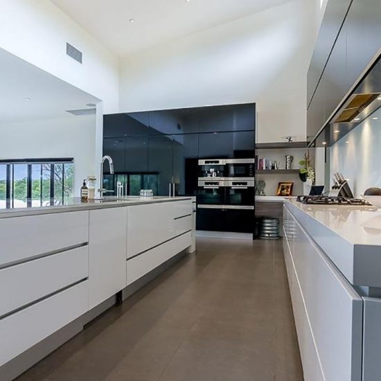 kitchen design, timber veneer, timber veneer cabinet, floating shelves, wall ovens, miele ovens, black cabinets, black gloss cabinets, white benchtop, stone benchtop, white cupboards, black and white