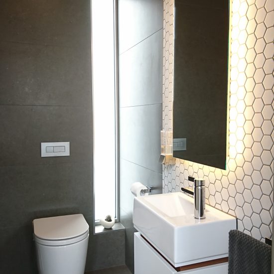 Bathroom design, contemporary bathroom, powder room, hexagonal mosaic tiles, feature tiles, wall hung toilet, Geberit toilet, in-wall cistern, wall hung vanity, custom joinery, backlit mirror