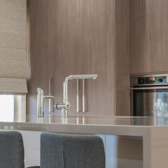 Kitchen design, contemporary kitchen, woodgrain laminate, stone benchtops, waterfall edge, Zip Hydro tap